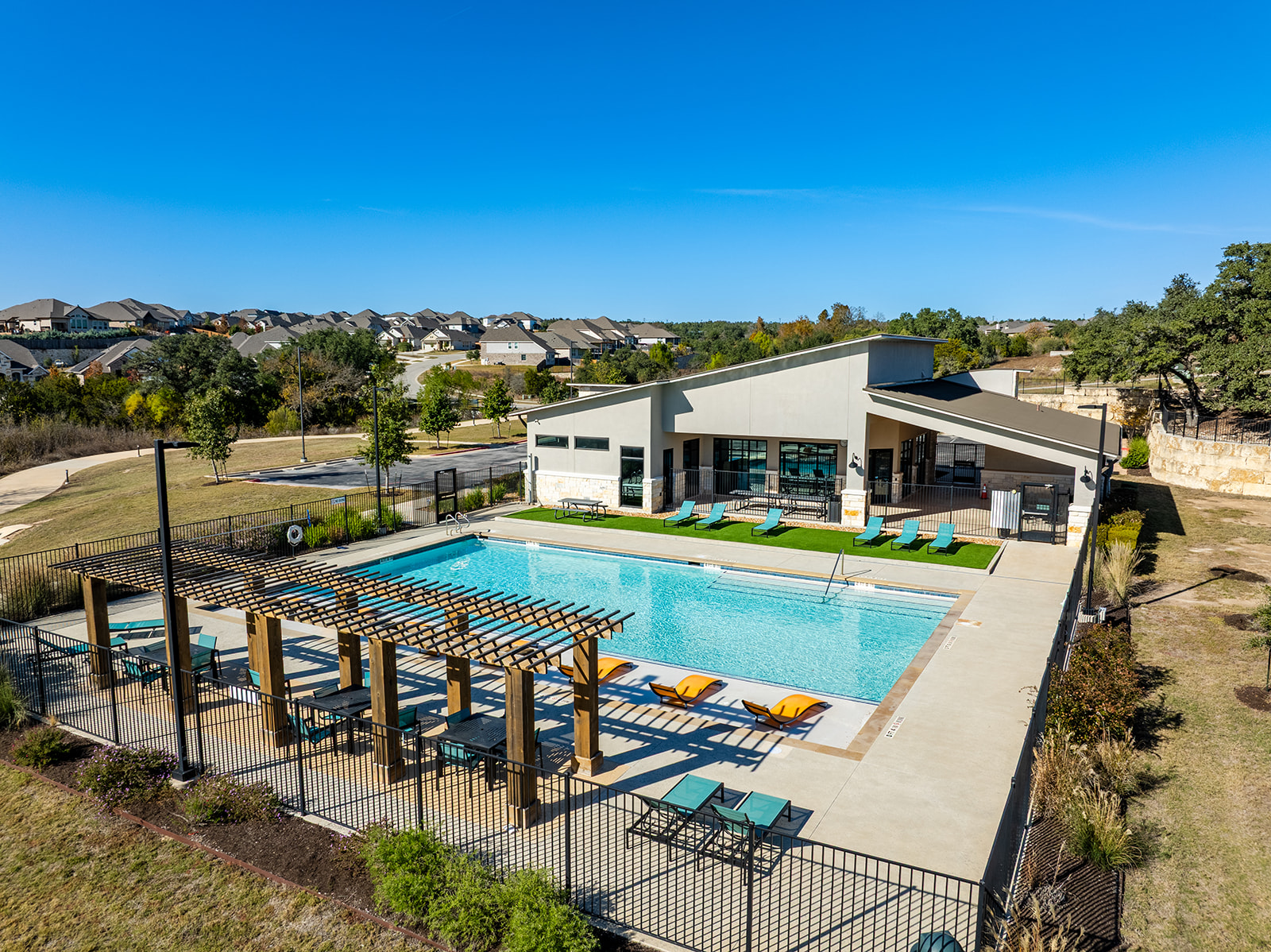 Water Oak community pool and clubhouse — resort-style pool with pergola, lounge chairs and neighborhood views